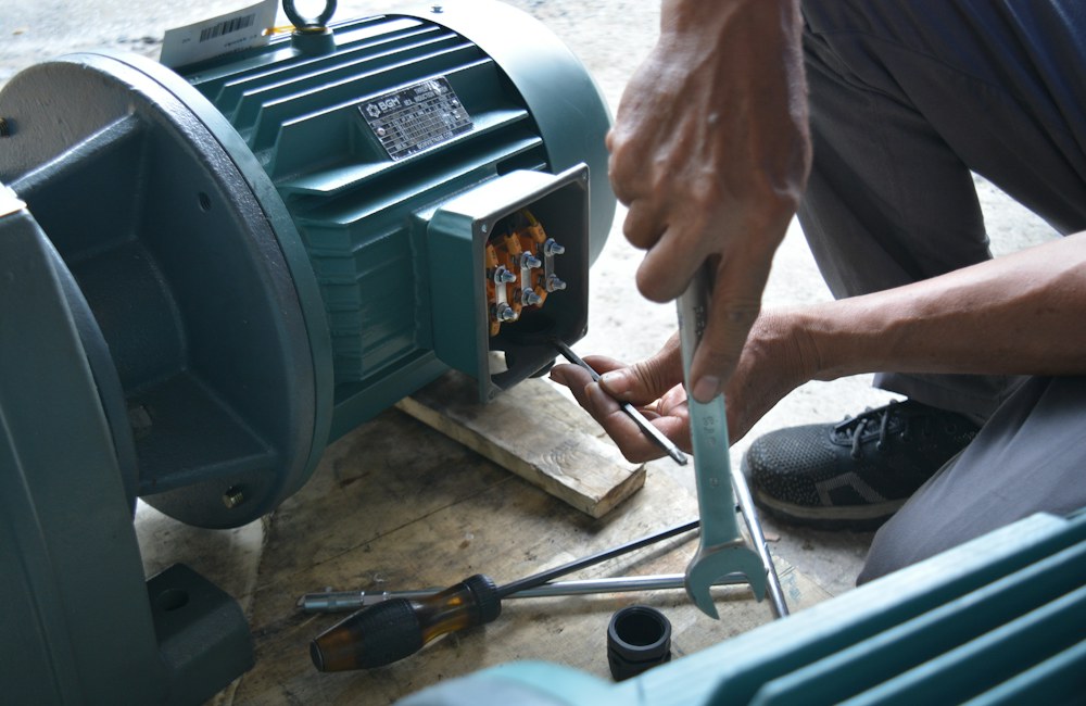 Technician working on a motor during repair